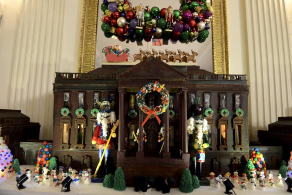The White House created in brown chocolate, is decorated with a wreath, toys, Nutcracker dolls and trimmings, in the State Dining Room of the White House. REUTERS/Mike Theiler
